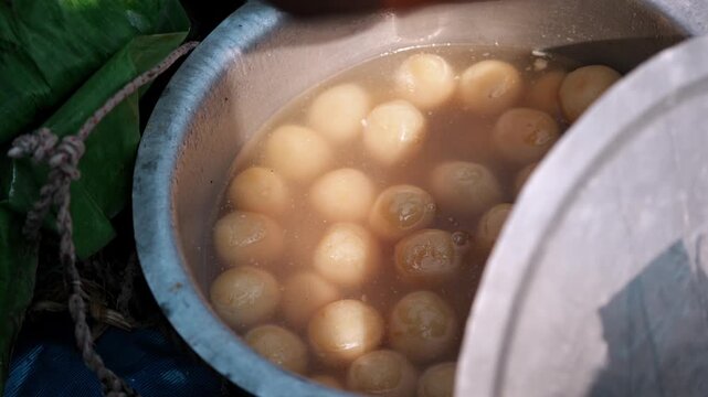 A street vendor sells rasgullas at a local fair