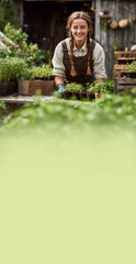 Smiling Young Woman Gardener Working with Seedlings in Rustic Potting Shed © elvil