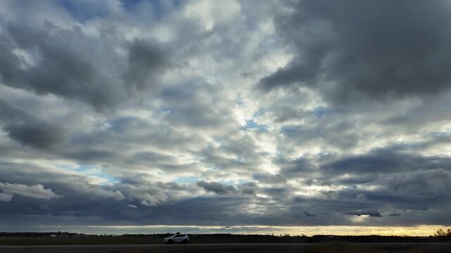 Driving on Highway During Autumn at Dusk With Cloudy Skies