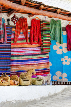 Colorful textiles displayed outside a local market in a village Capileira.