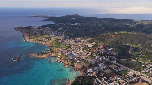 Aerial drone view of the Cape Greco Peninsula, Cyprus, featuring rugged coastline, small bays, and natural vegetation surrounded by deep blue Mediterranean waters