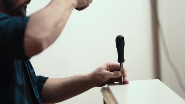 Handyman using hammer to assemble wooden shelf, furniture installation process, high quality 10 bit 4K.