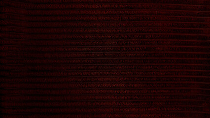 rich dark red corduroy texture closeup captures horizontal ridges in mysterious moody atmosphere © Arthur