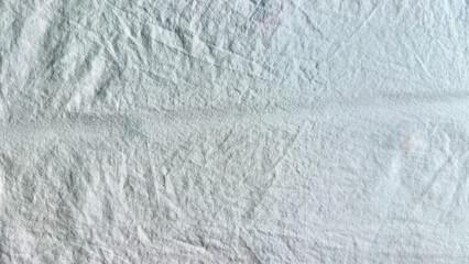 wrinkled white fabric macro closeup revealing horizontal crease and intricate fold textures in calm...