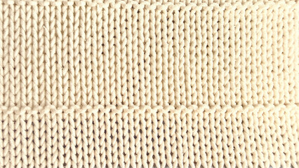 Fototapeta premium soft cream ribbed knit fabric closeup with intricate yarn texture and horizontal pattern band detail