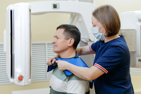 Male patient positioned for panoramic dental xray in radiologist clinic