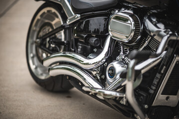 Fototapeta premium Motorcycle chrome engine exhaust wheel metal shine custom detail speed motorcycle chrome engine exhaust wheel metal shine custom detail speed power reflecting pavement closeup mechanical style