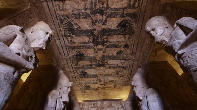 Ancient Egyptian chamber with statues and decorated ceiling inside the Abydos Temple, showcasing sacred architecture, carvings, and timeless spiritual symbolism. Egypt.