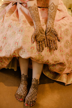Intricate Traditional Arabic Mehndi Art Adorns a Young Woman's Hands and Feet, Showcasing a Beautiful Henna Tattoo Design for Celebration