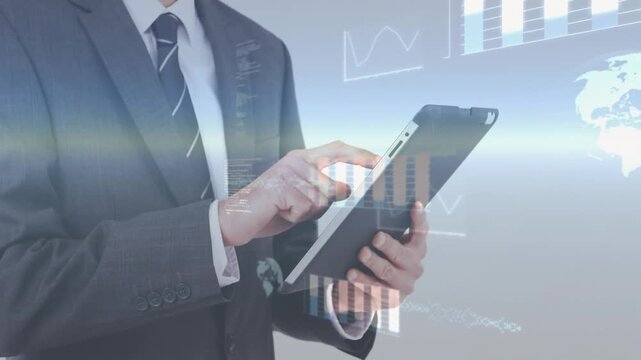 Male exec holding tablet tapping and swiping screen driving charts globe code overlay intensifying
