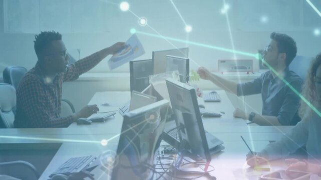 Left worker picking paper extending across monitors overlay drifting right worker taking for review