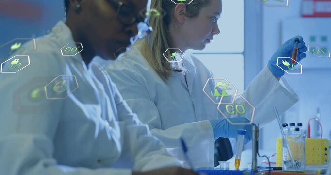Lab team picking pipet and drawing orange sample for experiment, green hex icons drifting at bench