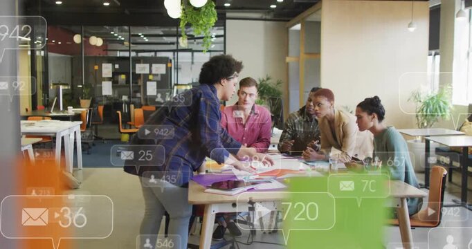Lead walking to table, sorting color pages and leading design session with alerts floating on table