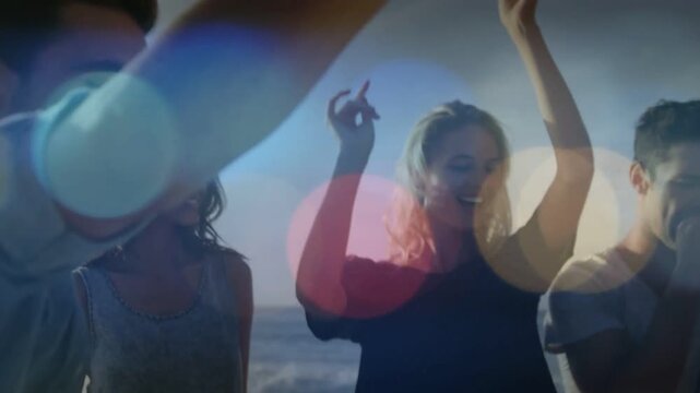 Singing friends clapping and swaying at sandy shoreline, denim shirt, ocean waves, lens-flare