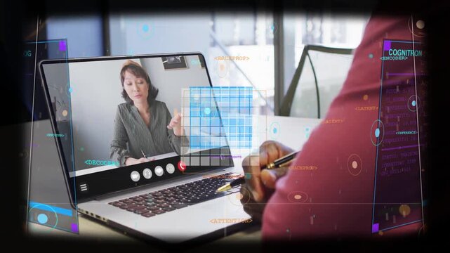 Business speaker presenting project on laptop, peer jotting notes as HUD overlays sweeping laptop