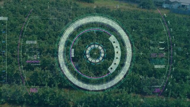 Aerial feed activating HUD scanning orchard while rings rotating and view panning for crop mapping