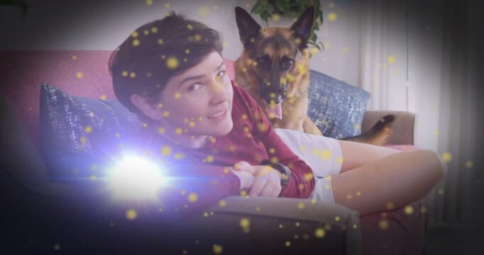 Woman smiling to camera after dog climbing nuzzling shoulder seeking attention, pet golden flare