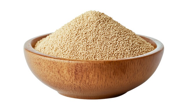 Heap of dry granular yeast in a light brown wooden bowl with a visible grain texture on its exterior, isolated on transparent.