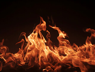 Fototapeta premium Abstract fire flames burning bright on black background creating dramatic orange glow with intense heat and smoke effects.