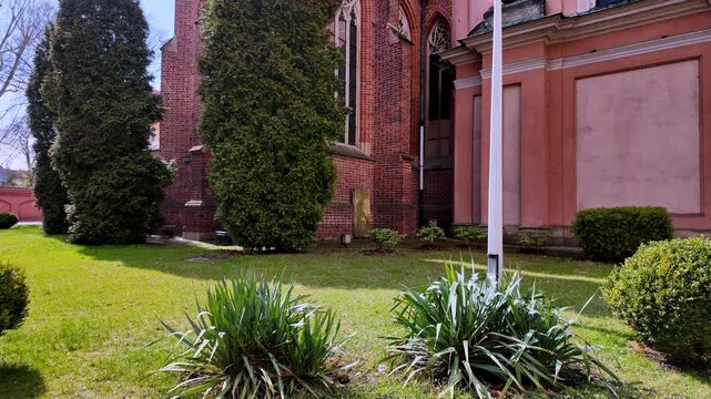 Cathedral of St. John the Baptist in Wroclaw Poland, gothic brick walls and pink baroque chapel, cathedral garden at Ostrow Tumski, historic religious architecture, sunny day in Silesia.