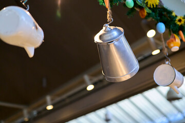 Coffee maker. Metal carafes hanging from a kitchen ceiling