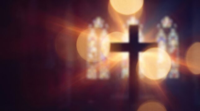 Dark silhouette of a christian cross against blurred glowing golden faith d
