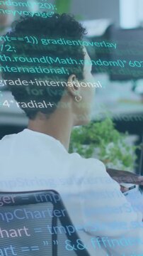 Vertical video: Female dev following coworker pointing using keys teal code scrolling across screen