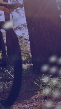 Camera panning upward, cyclist bringing bicycle in, overlay mapping trail data for tech demo