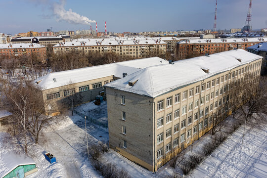 Tyumen, Russia - February 14, 2016: High-angle drone shot of Municipal Autonomous Educational Institution Secondary School No. 17 (MAOU SOSH No. 17) in Tyumen, Russia, captured on February 14, 2016