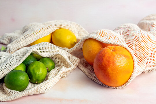Grapefruit, lemon and limes in reusable grocery produce mesh bag