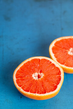Grapefruit cut in half on colorful surface 