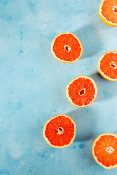 Grapefruit cut in half on colorful surface 