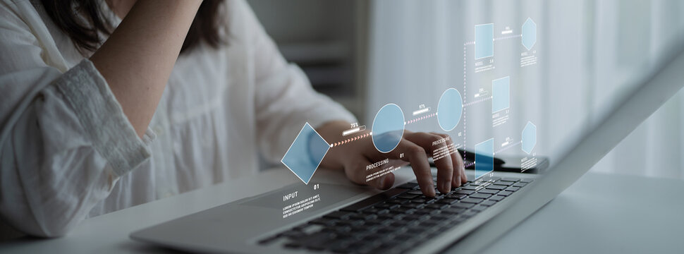 Person Using Laptop with Digital Interface Displaying Data Visualization and Graphs in Modern Workspace Environment Quark.