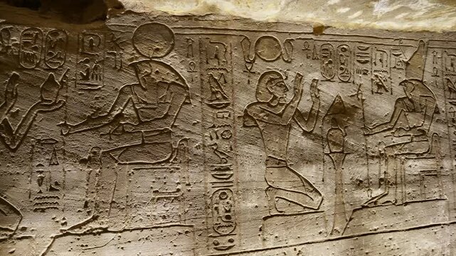 Ancient Egyptian wall paintings with detailed hieroglyphs and ritual scenes inside the Abydos Temple, revealing sacred art, mythology, and preserved history. Egypt.
