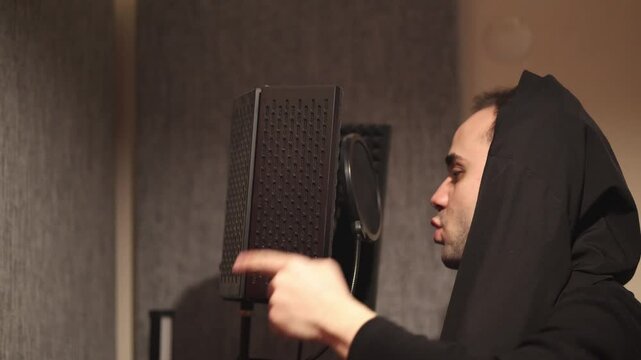 Rapper Recording Track on Microphone in Studio