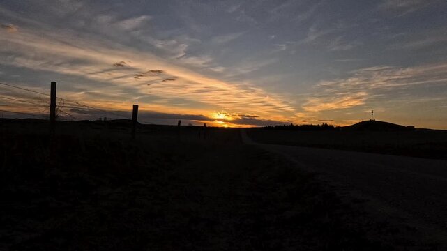 Slow clouds streaming across the sky, on a beautiful spring evening, near the small town of Lusk Wyoming. Time-lapse video show the wind coming from the west north west direction.