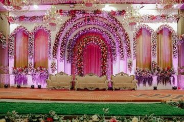 Lavish Floral Wedding Stage Decoration with Elegant Seating and Sparkling Chandeliers for Grand...