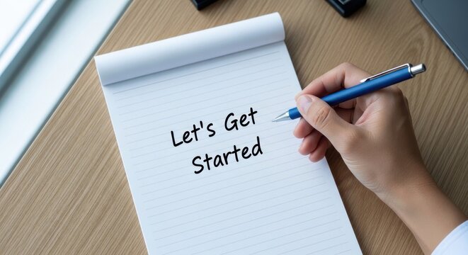 Hand Writing Lets Get Started on a Notepad with a Pen.