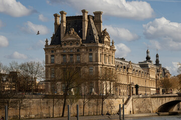 Obraz premium A view of the Flora Pavillion, the Louvre Museum, Paris taken from a boat on the river Seine.