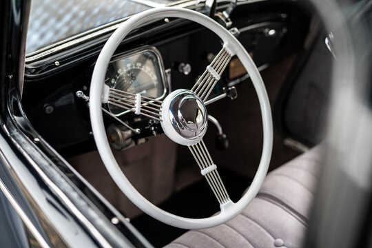Vintage Steering Wheel and Classic Car Interior With Retro Chrome Details and Soft Bench Seat