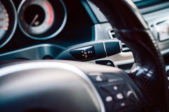 Close-Up Of Car Interior Steering Wheel And Automatic Gear Selector Stalk In Modern Luxury Vehicle