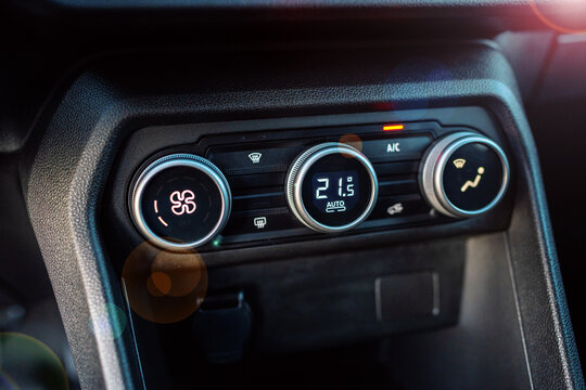 Car Climate Control Panel With Digital Temperature Display and Knobs in Modern Dashboard