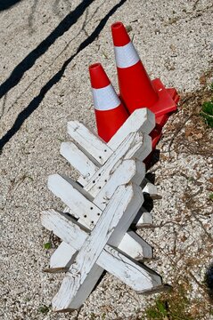 traffic cone on the road
White wooden cavaletti jumps and red traffic cones for horse training on a gravel arena.