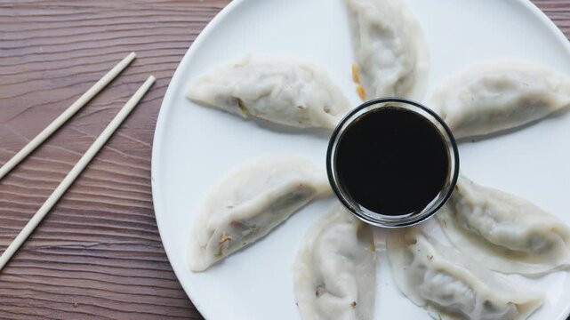 Close-Up of Gyoza with Soy Sauce Served on White Plate