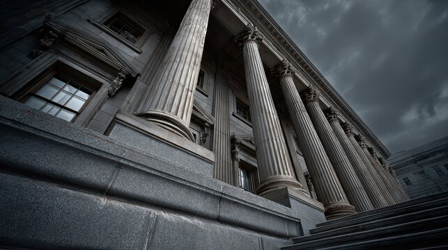 Abstract low-angle view of a neoclassical courthouse facade with fluted columns and stone steps