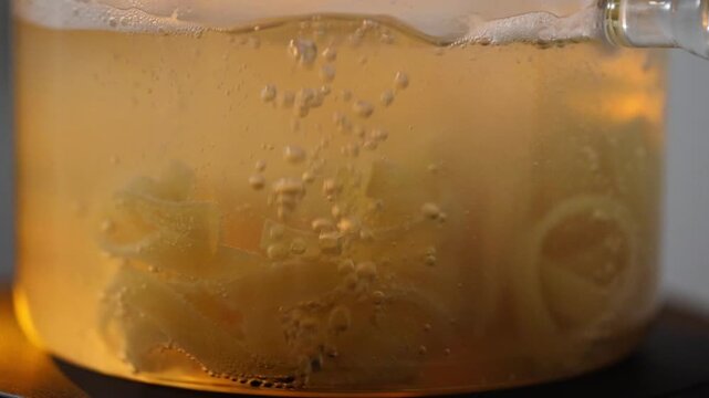 Pasta boiling in a transparent pot on a stove, showing a clean and minimal cooking process suitable for both home kitchens and professional restaurant environments.