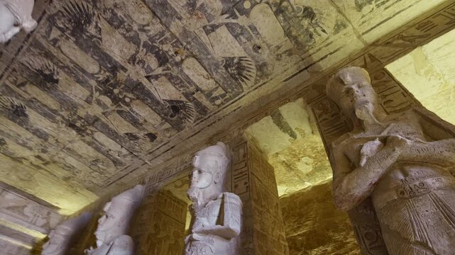 Ancient Egyptian chamber with statues and decorated ceiling inside the Abydos Temple, showcasing sacred architecture, carvings, and timeless spiritual symbolism. Egypt.