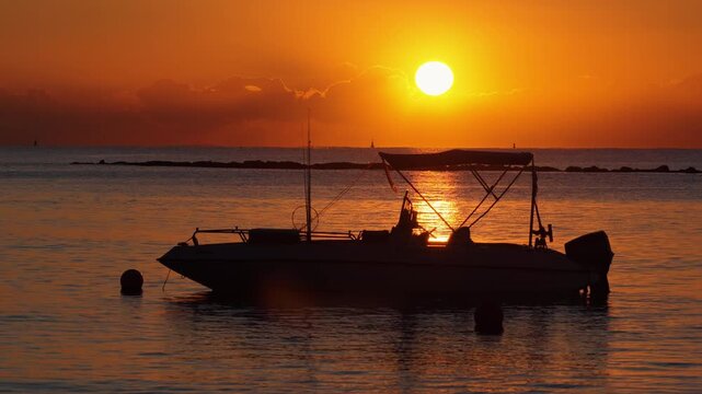 Aerial drone view of a boat silhouette during sunset on the Mediterranean Sea near Limassol Marina, Cyprus