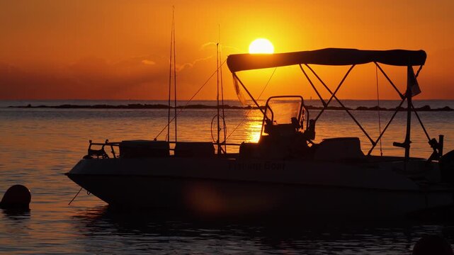 Aerial drone view of a boat silhouette during sunset on the Mediterranean Sea near Limassol Marina, Cyprus