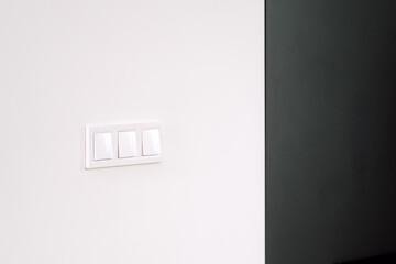 White light switch on a white wall in living room